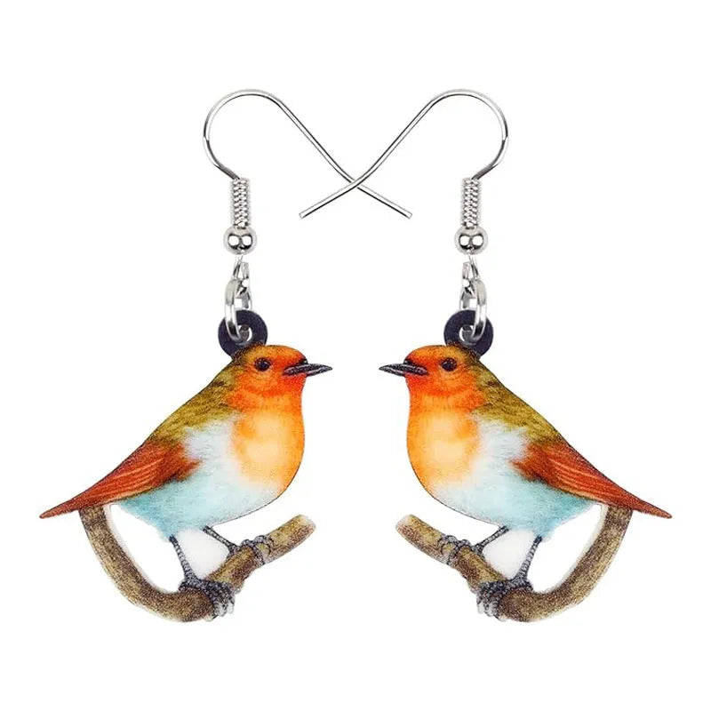 A pair of blue titmouse pendant earrings made from printed acrylic with a geometric, animal-inspired design.