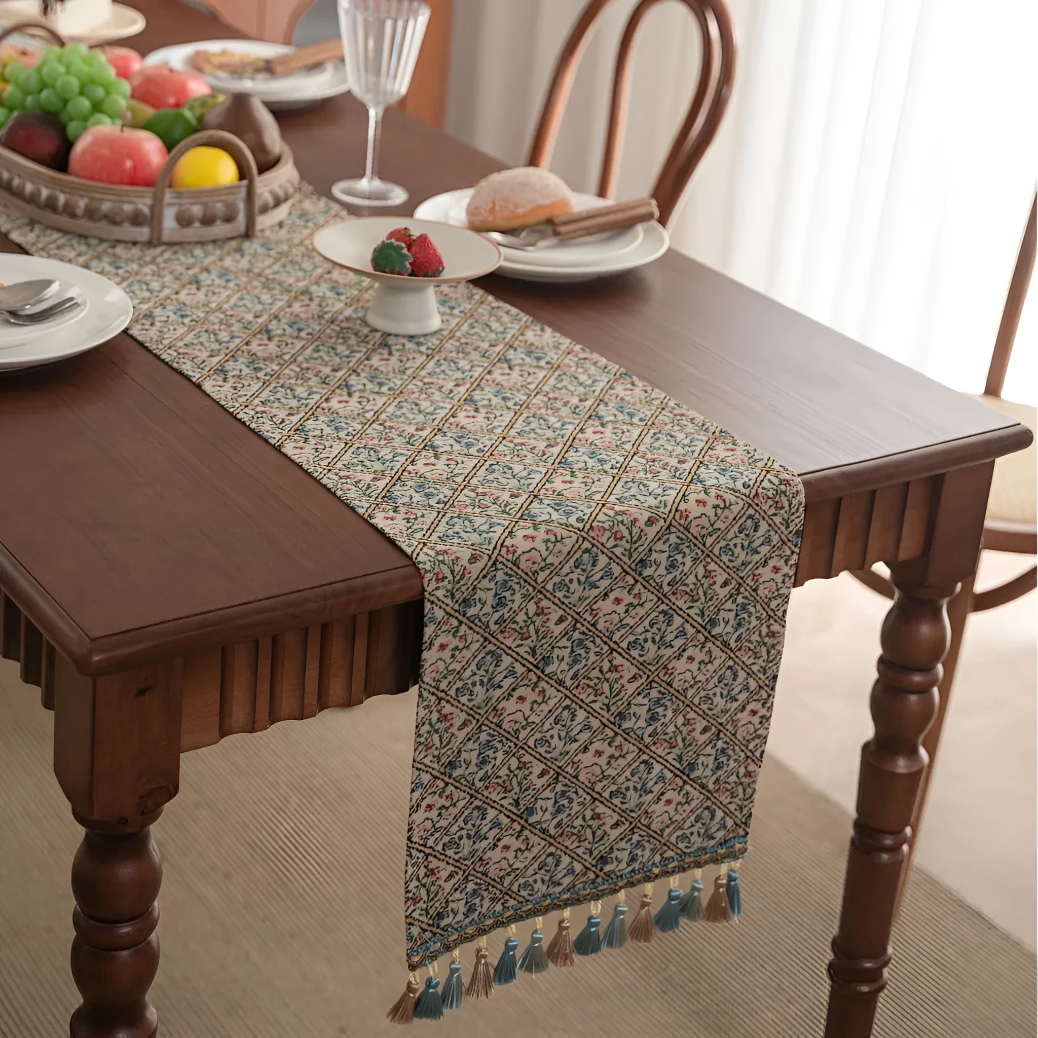 Dark blue striped jacquard table runner with tassel trim laid on a wooden table.