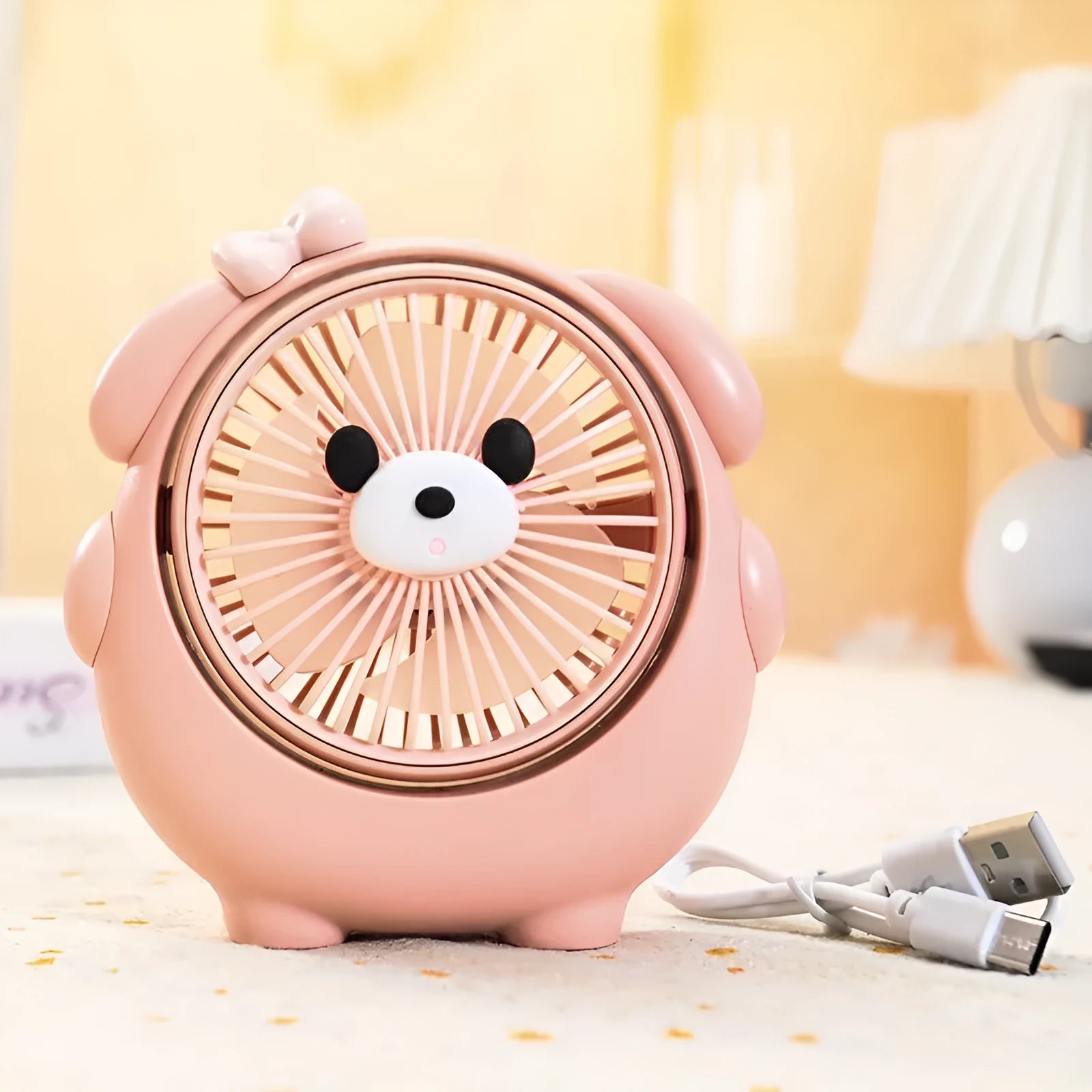 Cute dog-shaped USB desktop electric fan in a choice of colours including brown and pink, showing its plastic construction.