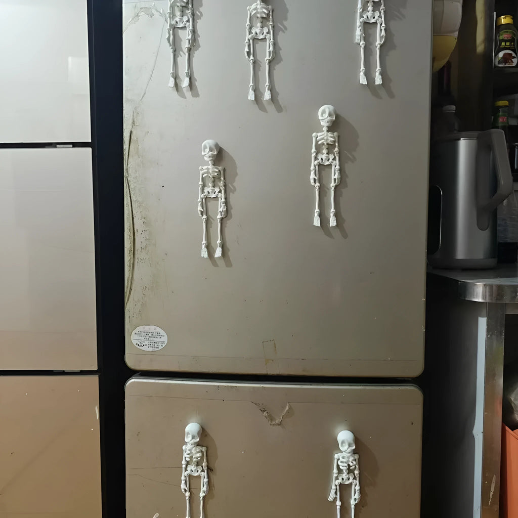 3D-printed PLA skull model Halloween fridge magnet ornament in luminous green colour.
