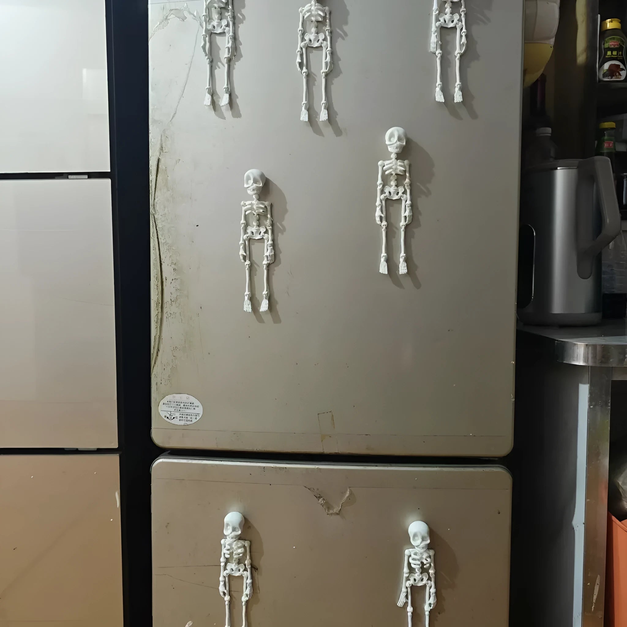3D-printed PLA skull model Halloween fridge magnet ornament in luminous green colour.