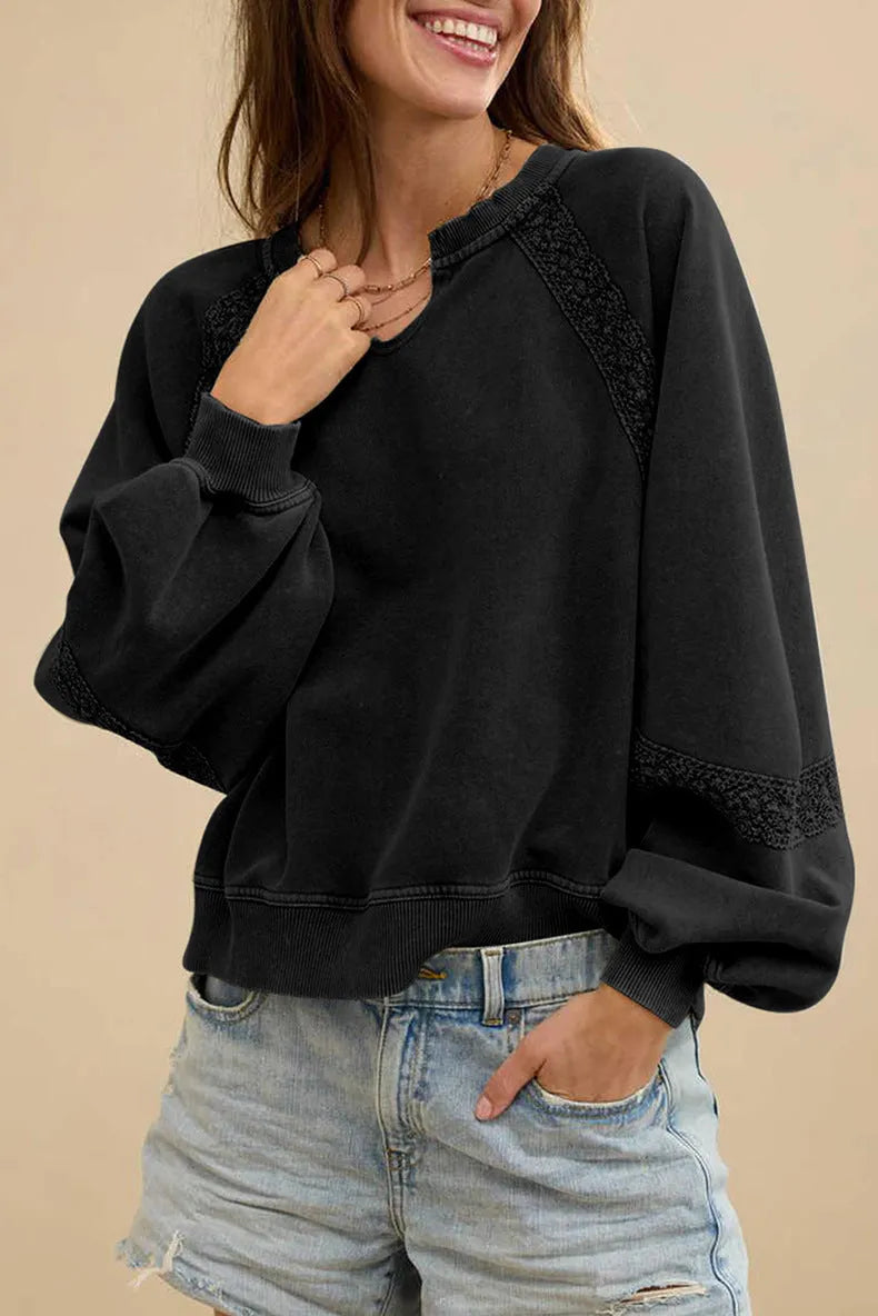 Women's loose fit sweater with lace-stitch half-open collar and long sleeves in a solid colour.
