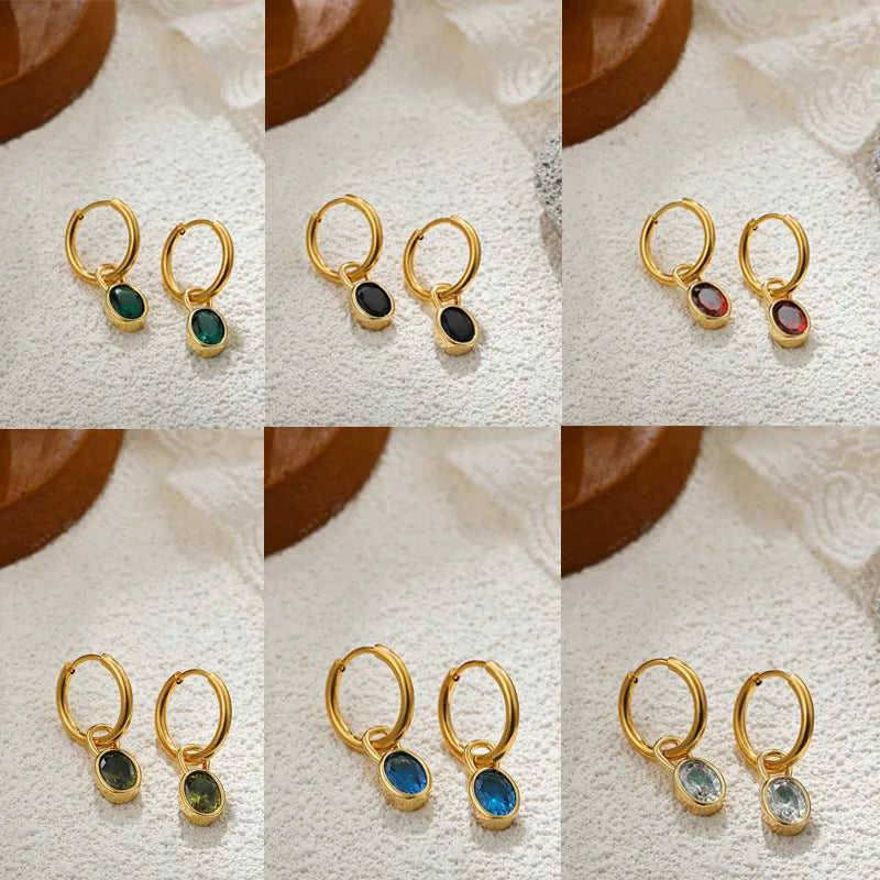 Women's oval-shaped retro zircon earrings in copper, shown in emerald green colour.