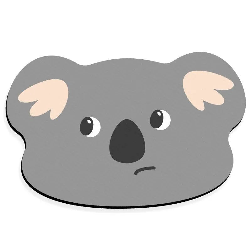 Cartoon animal diatom oil absorbent non-slip bathroom mat in alien shape on a bathroom floor.