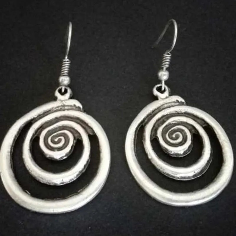 Silver geometric spiral distressed retro style earrings with a folk art design