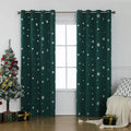 Red snowflake pattern shade cloth curtain with iron hoops hanging on a rod against a window.