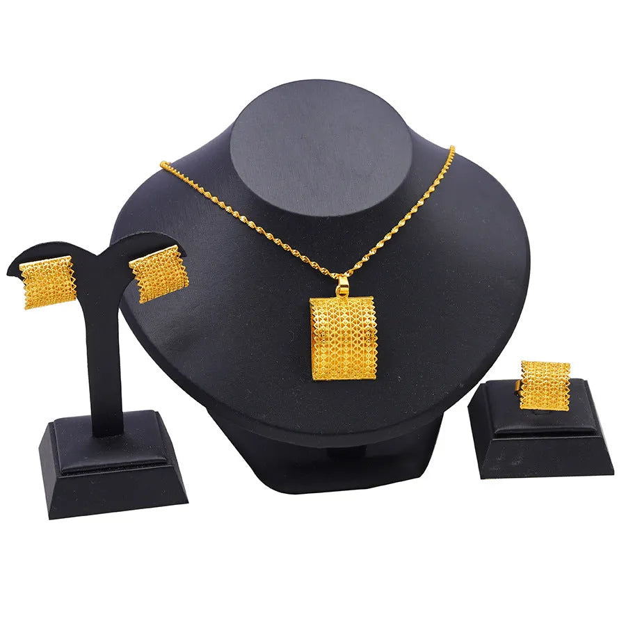 Gold coloured bridal jewellery set with necklace, earrings and ring on display