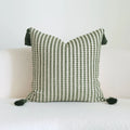 Green decorative pillow with tassel or beaded design on a cotton linen blend cover.
