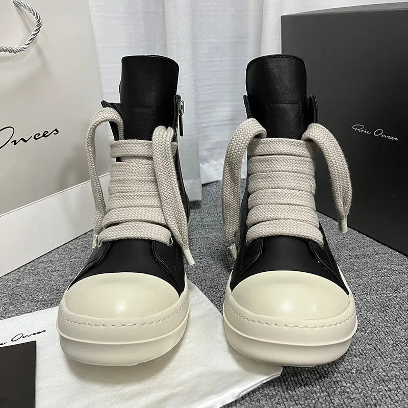 Men's and women's high-top leather sneakers in black with a side zipper and round toe on a rubber sole.