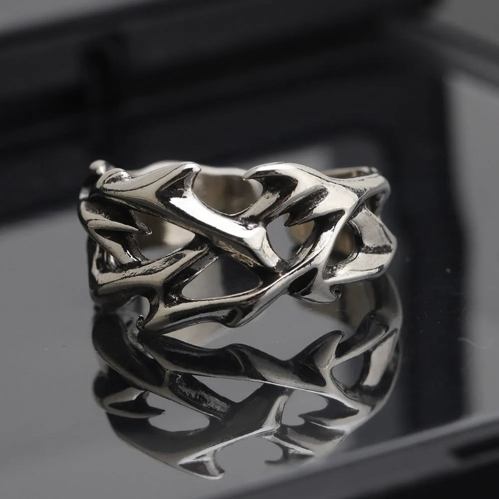 Copper men's ring with geometric thorn and flower design on an adjustable band.