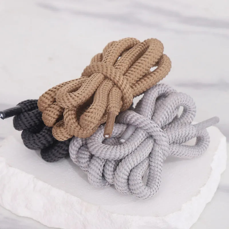 Black oval shoelace adapter rope showing round 1.0cm width, coiled to display length