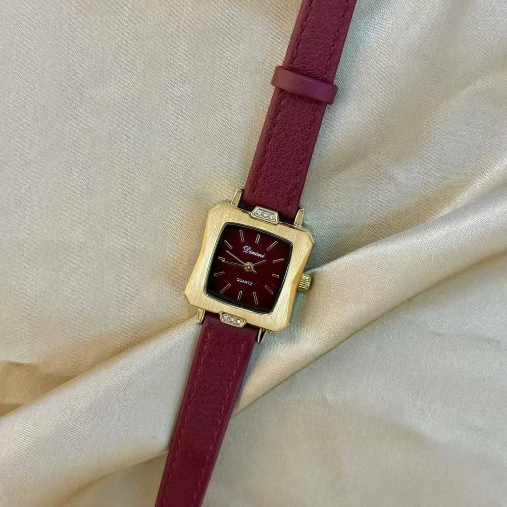 Red dial women's alloy watch with Chinese style decorative design on wrist.