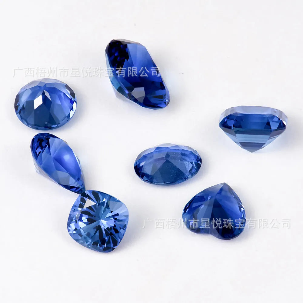 A single heart-shaped blue topaz loose gemstone on a plain background.