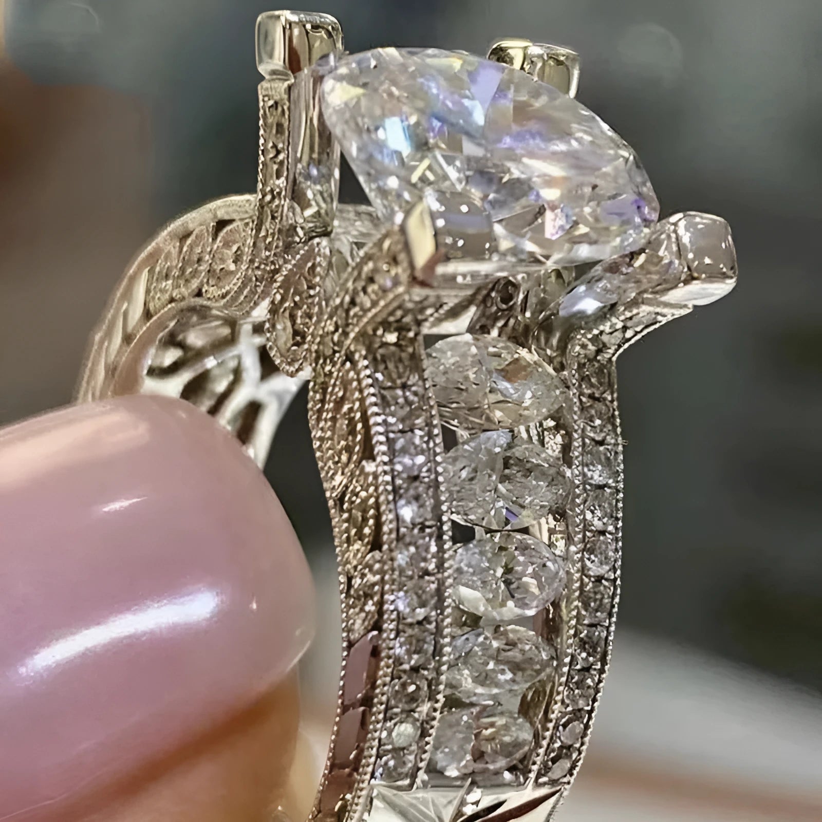 Geometric women's silver fashion ring with round details in gold or white electroplated finish on a finger.