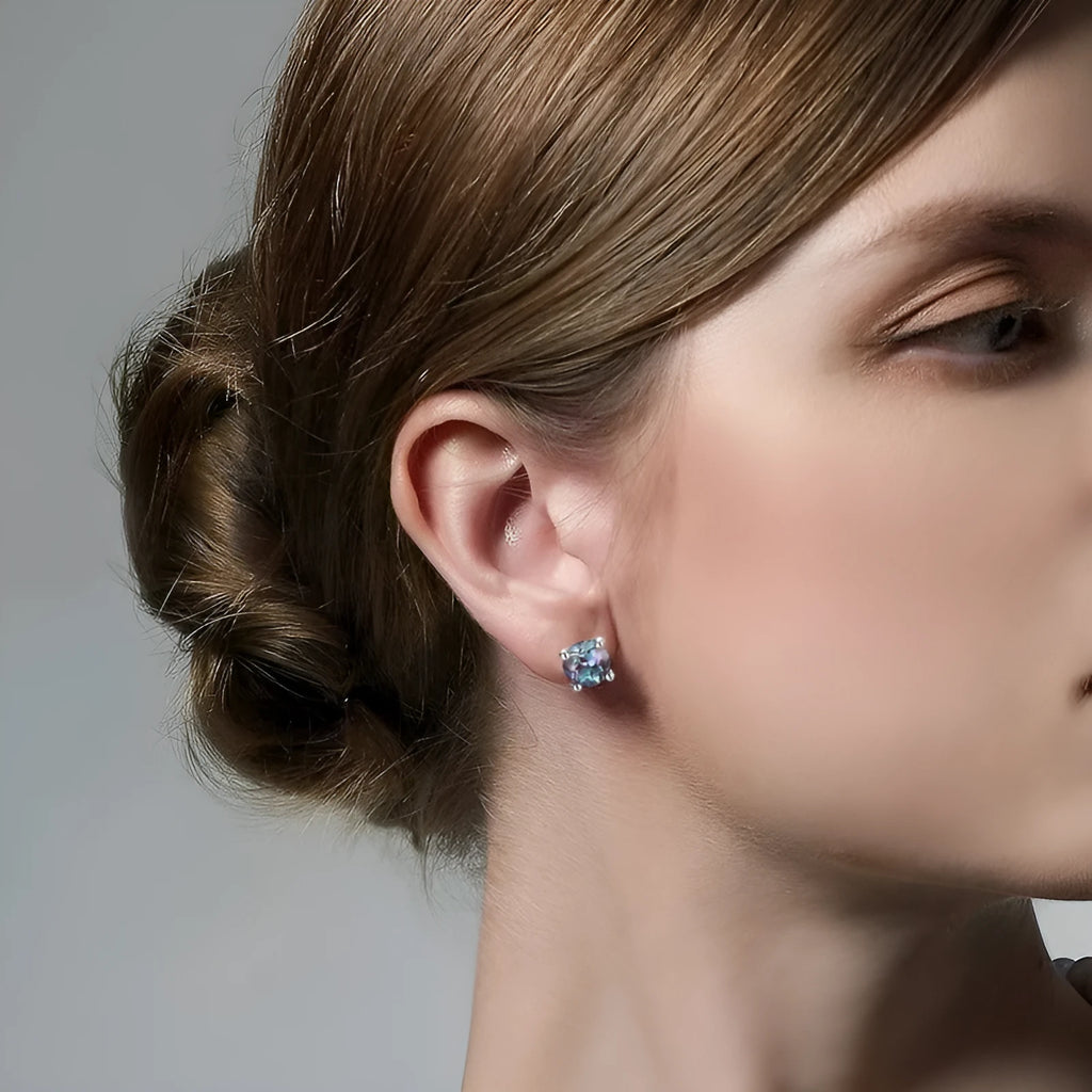 Simple geometric sterling silver stud earrings with a round cultivated Alexandrite stone.