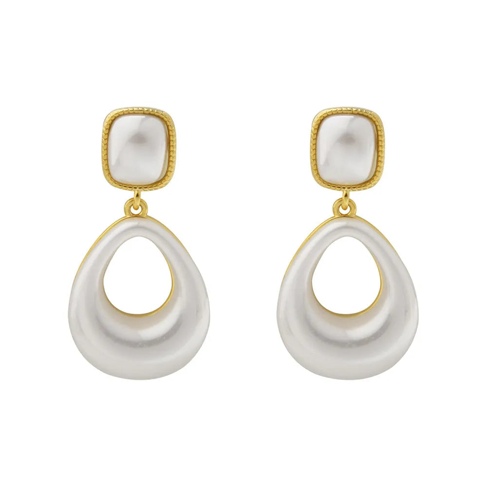 Gold coloured drop shaped earrings with a central imitation pearl, shown on a white background.