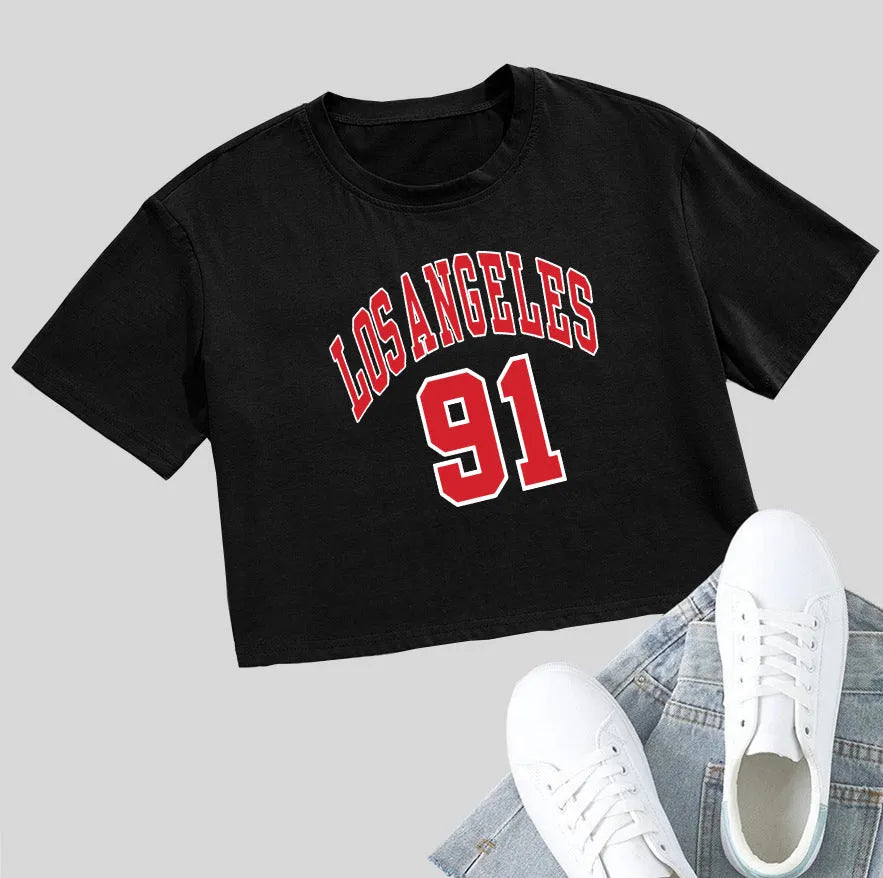A black loose-fit cotton T-shirt with white printed English letters and a short navel-baring cut.