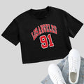 A black loose-fit cotton T-shirt with white printed English letters and a short navel-baring cut.