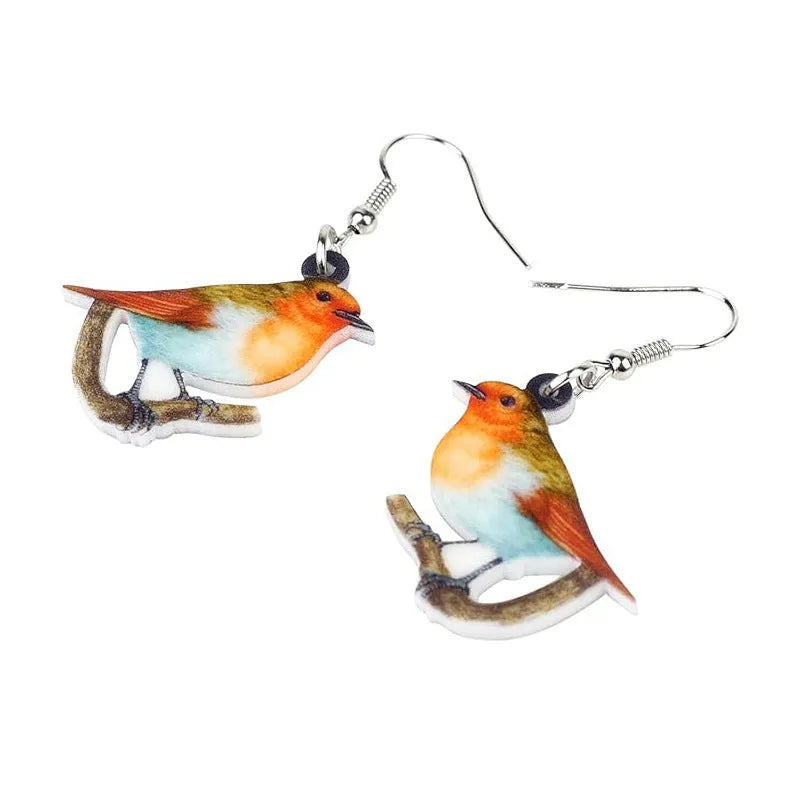 A pair of blue titmouse pendant earrings made from printed acrylic with a geometric, animal-inspired design.