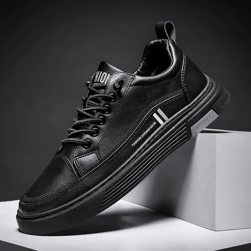 Men's low-top skate shoes in black with a round toe, elastic band, and rubber sole.