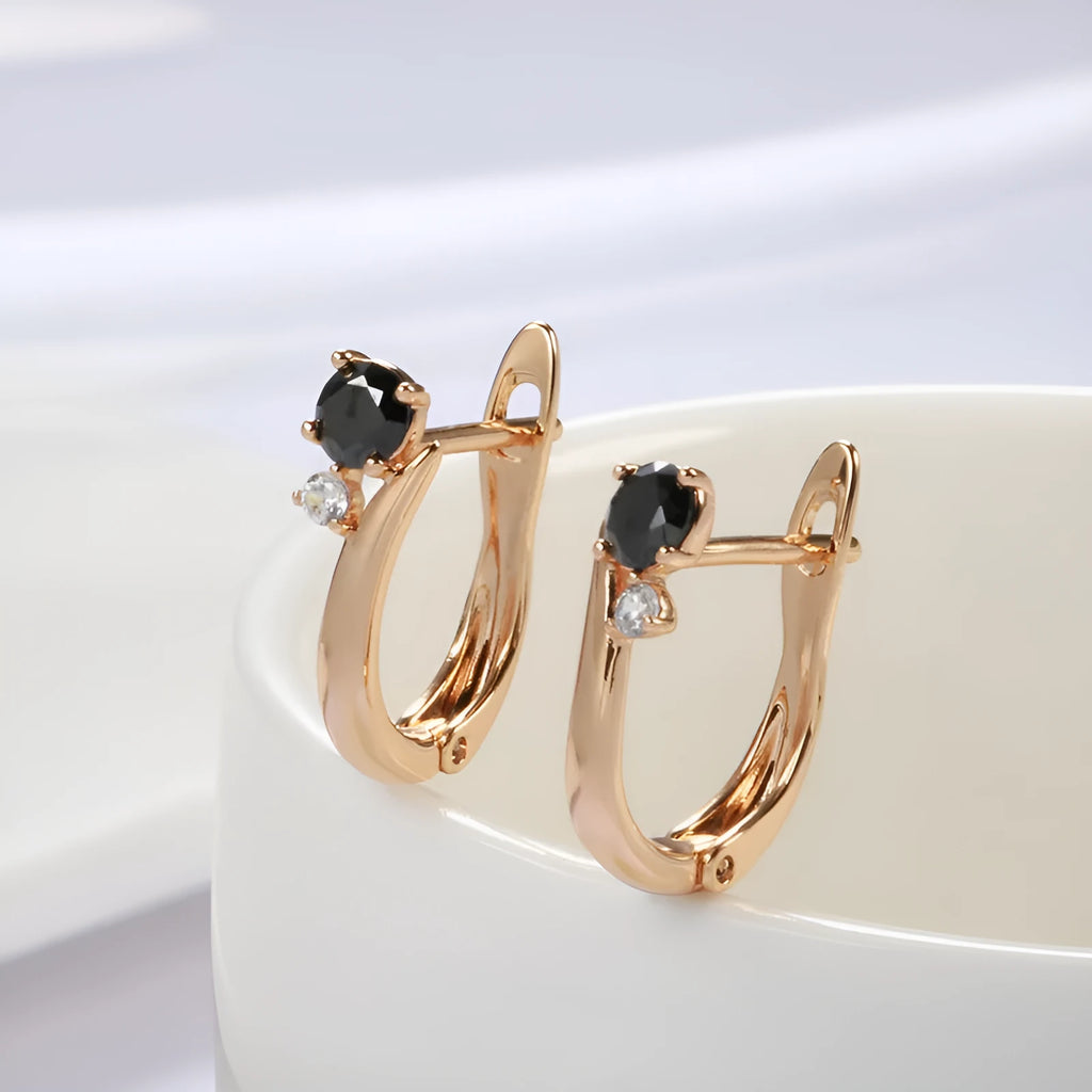 Gold drop-shaped earrings with geometric patterns and artificial gemstone inlay