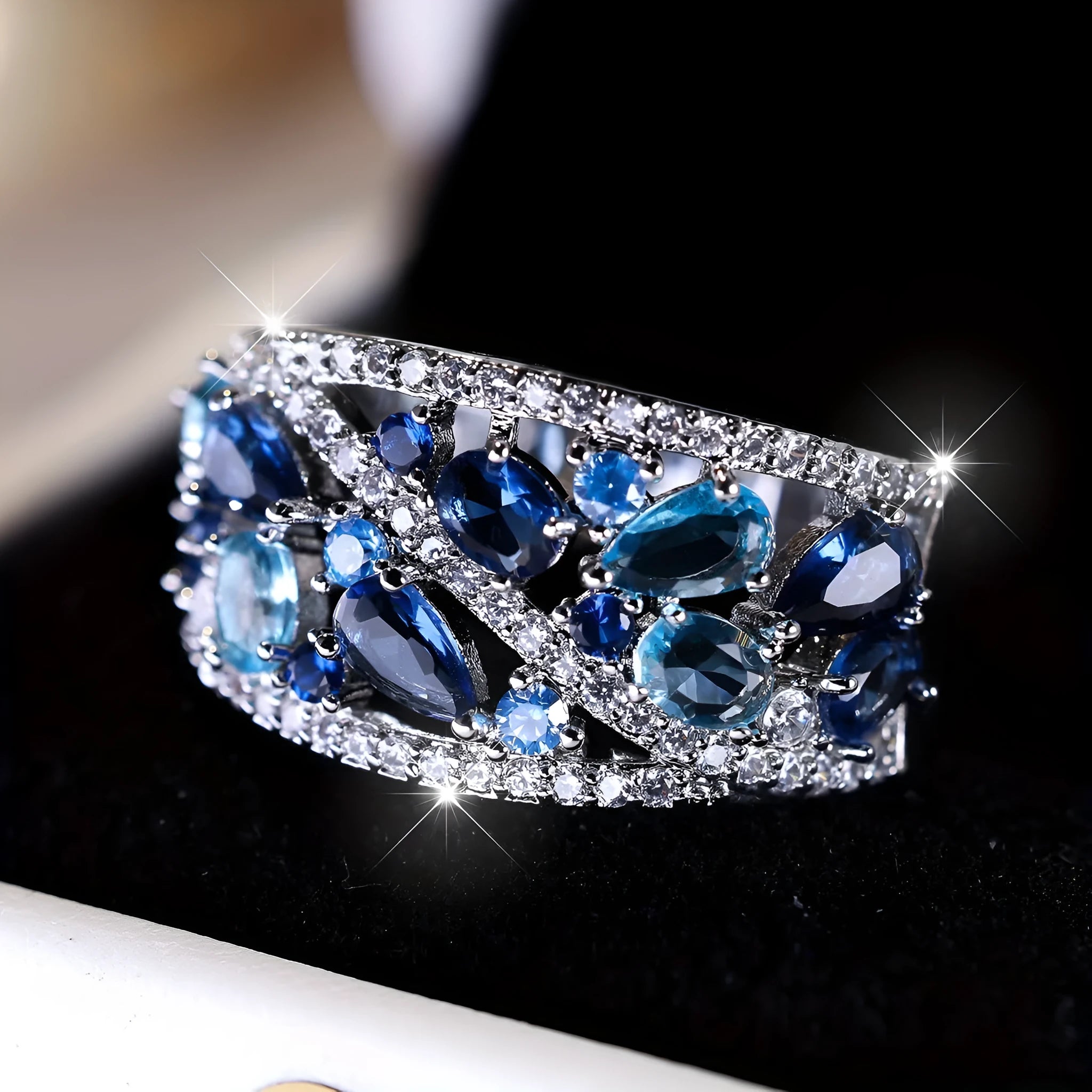 Women's round copper ring with hollow openwork centre in gold sapphire blue colour.