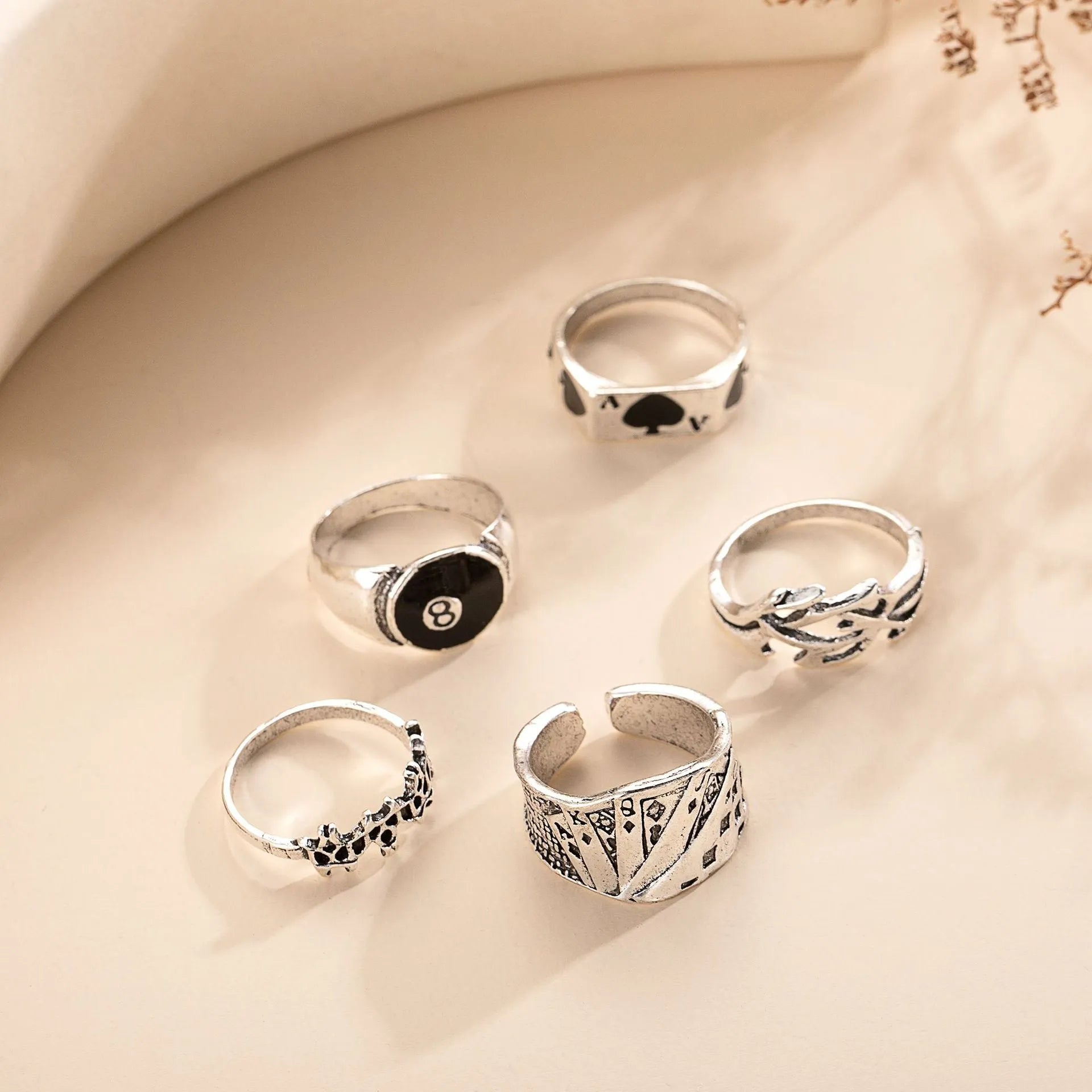 Black alloy ring with a detailed retro spade card poker design on a finger.