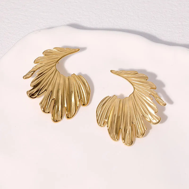 A pair of stainless steel earrings in a leaves shape with a gold electroplated finish.