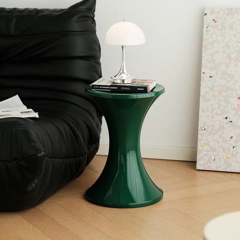Plastic hourglass-shaped shoe changing stool shown in a selected colour.