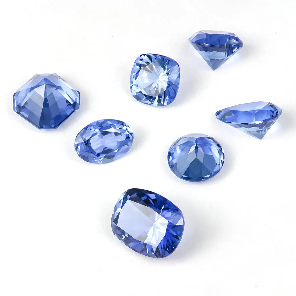 A single heart-shaped blue topaz loose gemstone on a plain background.