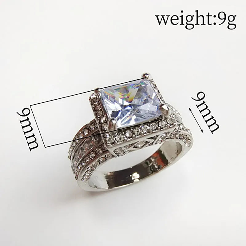 Geometric women's silver fashion ring with round details in gold or white electroplated finish on a finger.