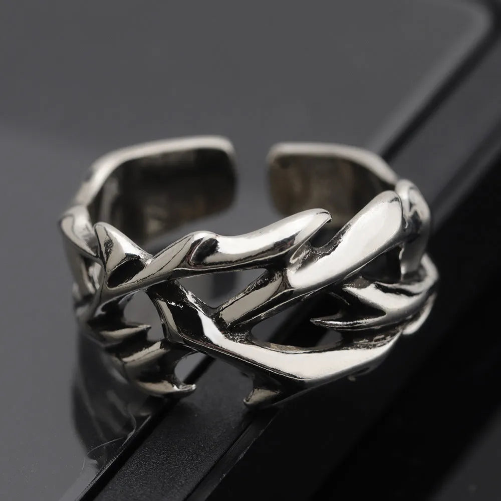 Copper men's ring with geometric thorn and flower design on an adjustable band.