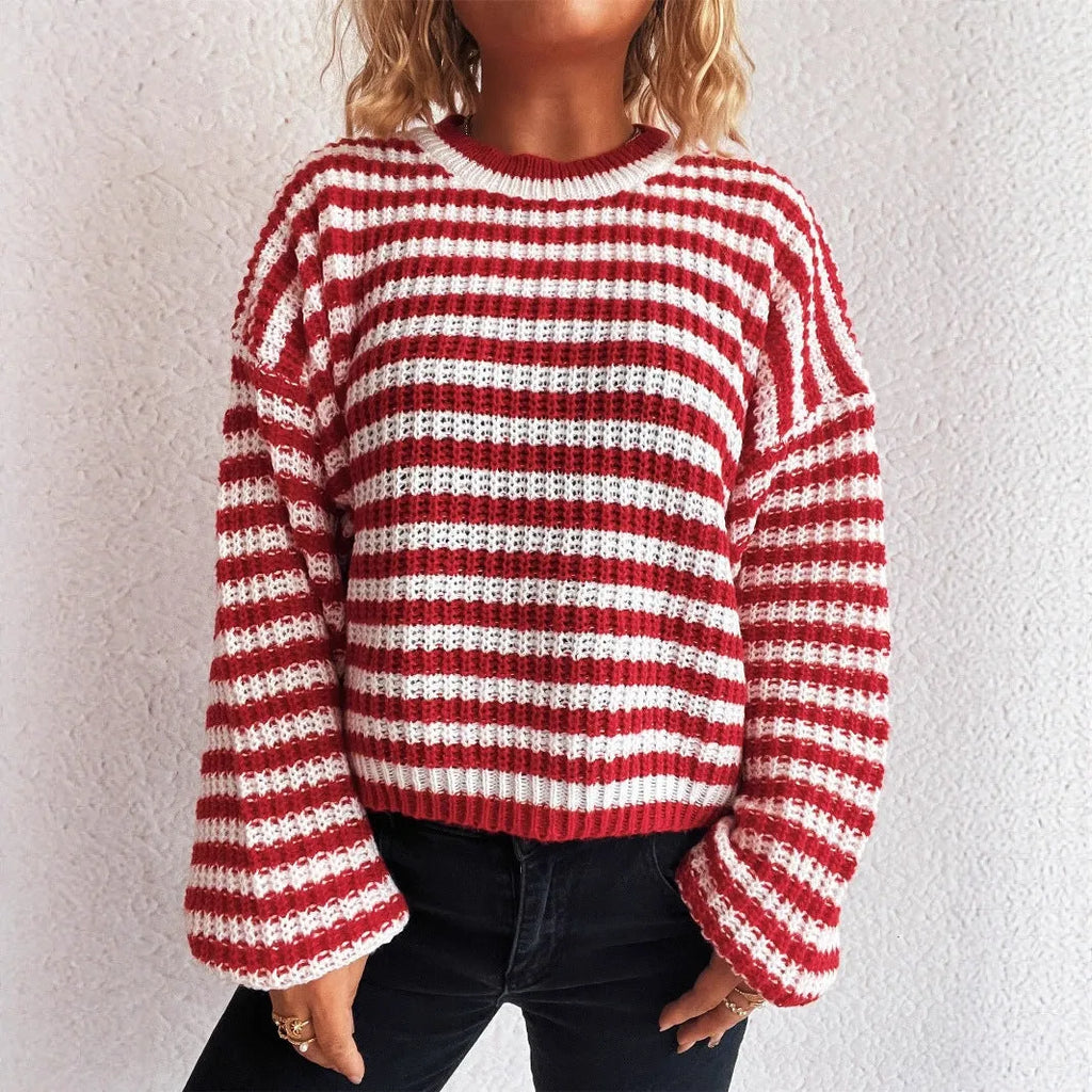 A woman's loose-fitting striped pullover sweater with a round neck and long sleeves in a khaki colour.