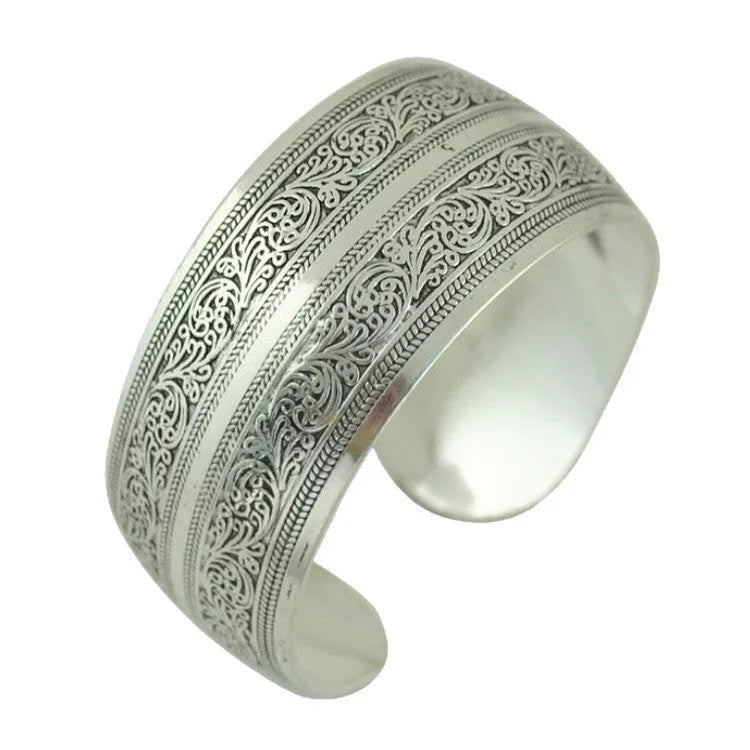 Open cuff bracelet with carved ethnic Miao silver design in alloy material