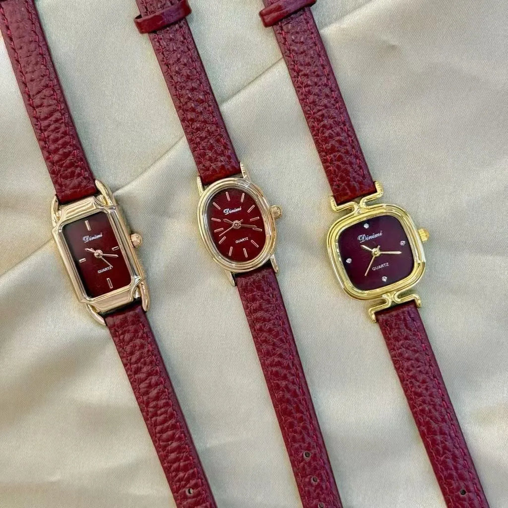 Red dial women's alloy watch with Chinese style decorative design on wrist.