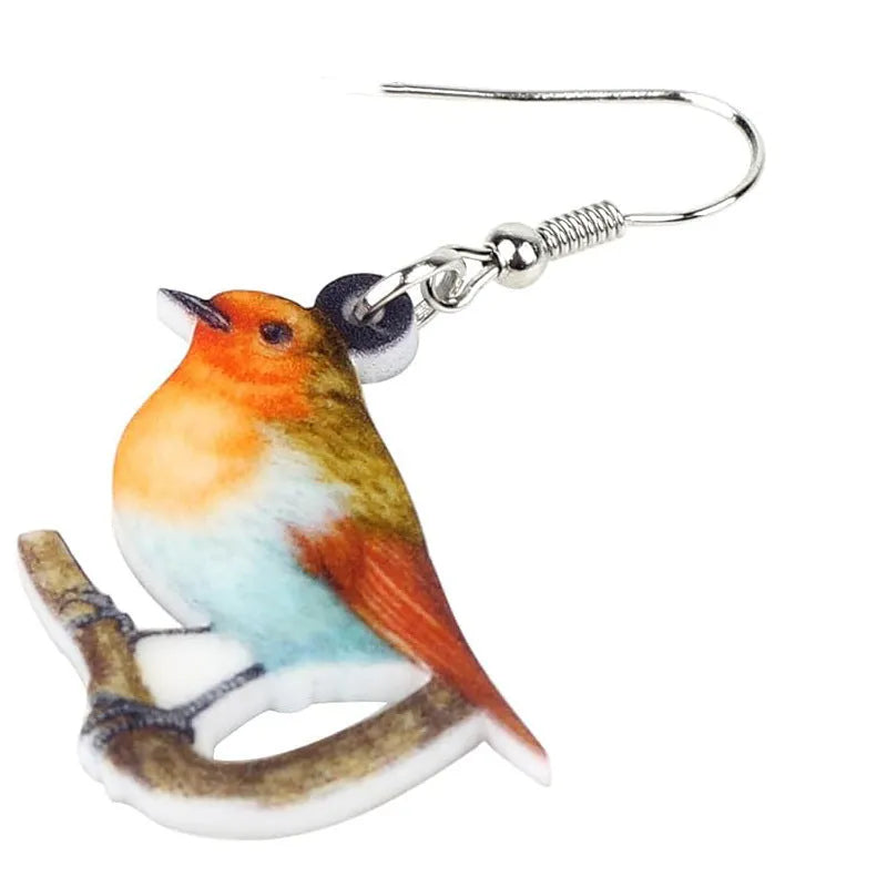 A pair of blue titmouse pendant earrings made from printed acrylic with a geometric, animal-inspired design.