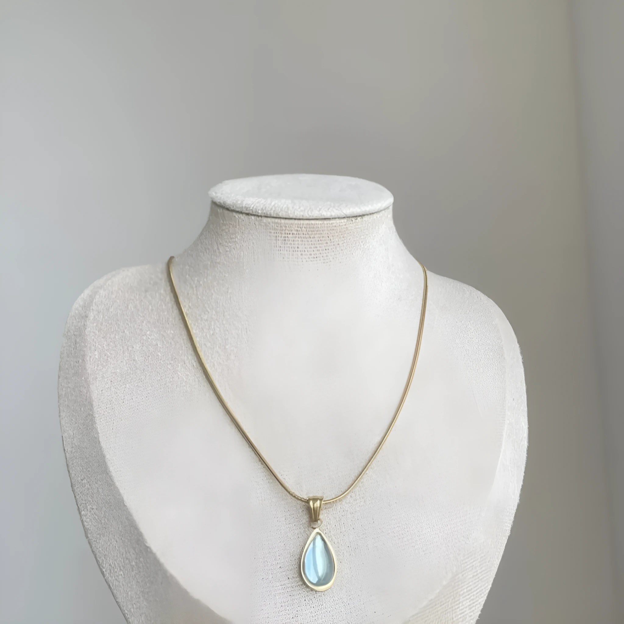 Retro titanium steel necklace with blue gemstone water drop pendant on a snake chain.