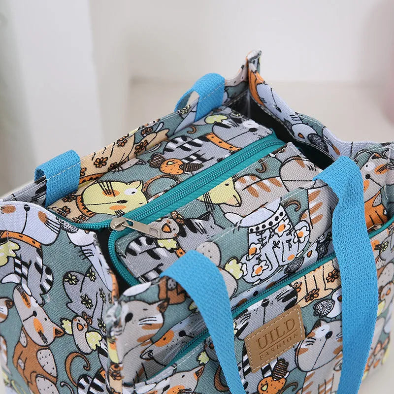 Women's printed canvas handbag with aluminium frame in a horizontal square shape, shown in a floral design.