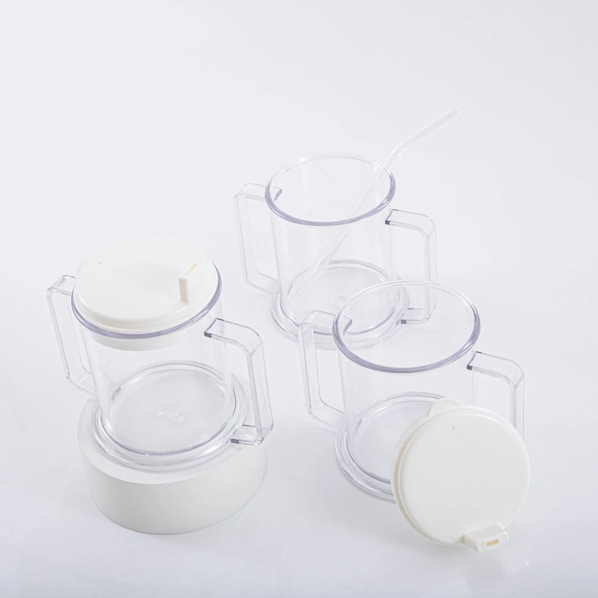 Transparent spill-proof drinking cup with straw lid showing modern minimalist design