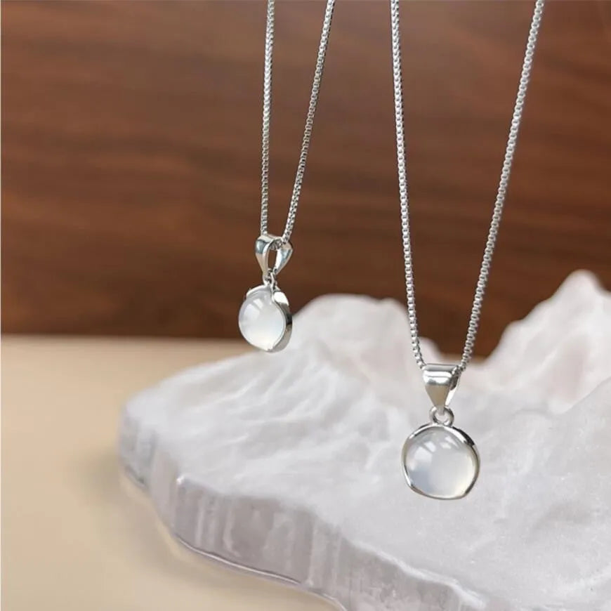 Women's oval artificial crystal pendant necklace with eight-point star detail on adjustable box chain