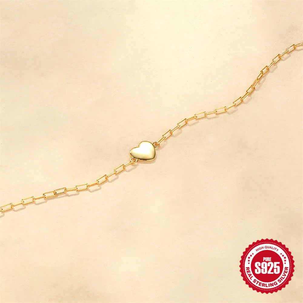 S925 sterling silver bracelet with geometric heart charm and clip chain fastening in gold plating