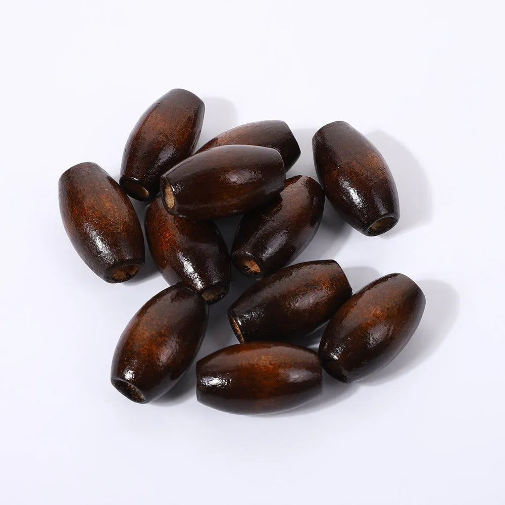 Oval M-shaped wooden bead in dark coffee colour with raised design, 25mm diameter