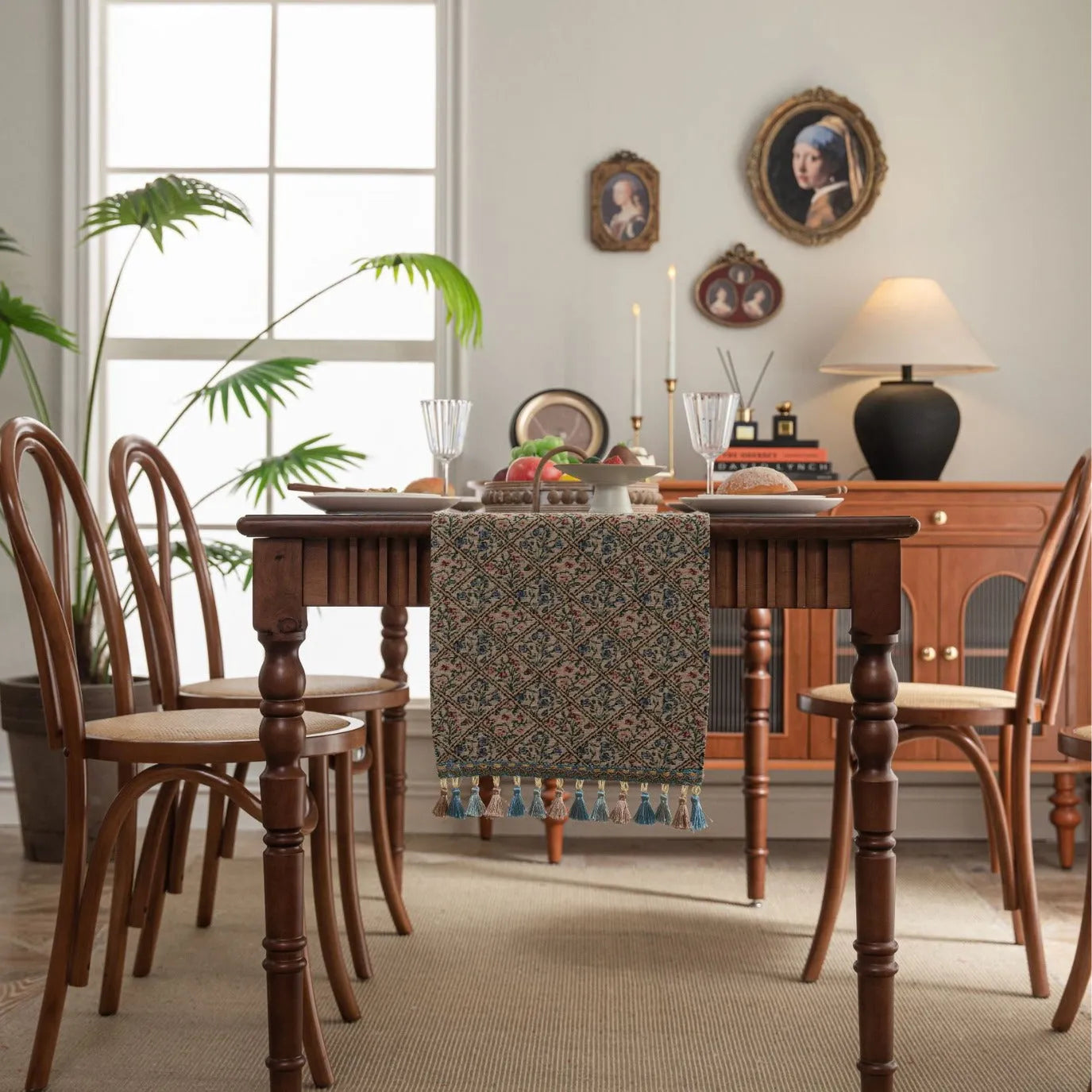Dark blue striped jacquard table runner with tassel trim laid on a wooden table.