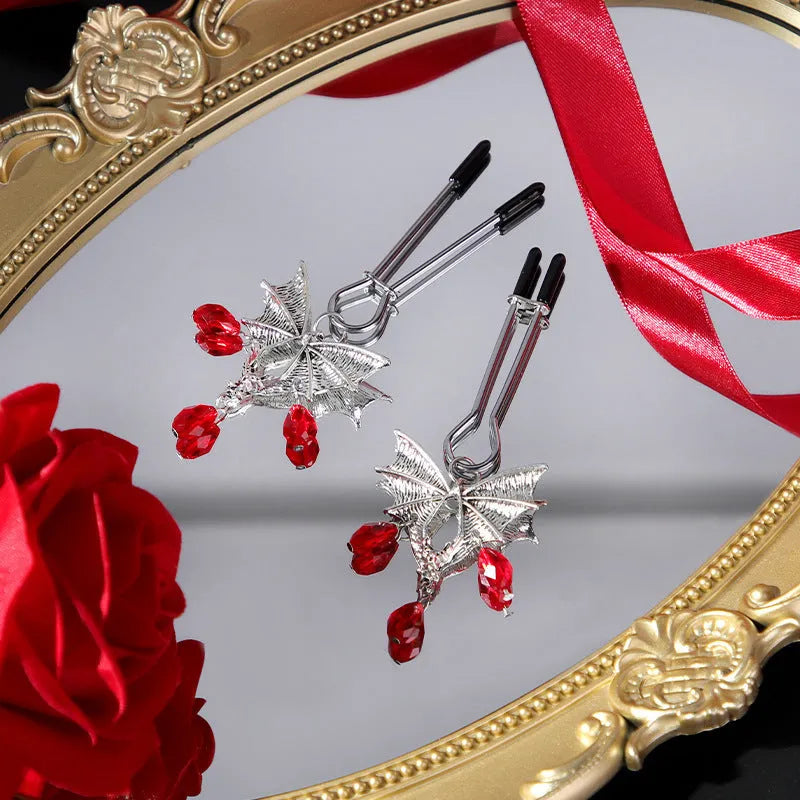 Silver bat nipple clamp with ruby detail and adjustable mechanism
