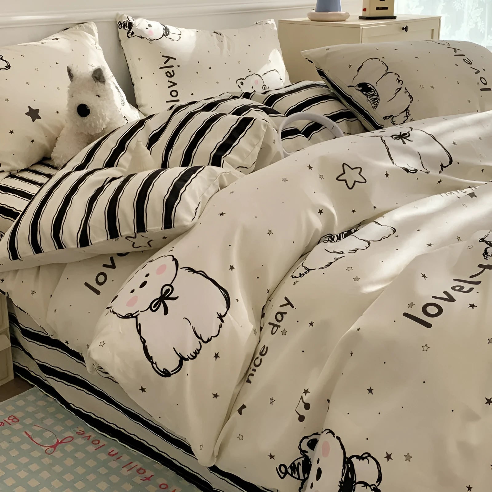 Cartoon dog pattern four-piece cotton quilt cover set laid on a bed.