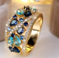 Women's round copper ring with hollow openwork centre in gold sapphire blue colour.