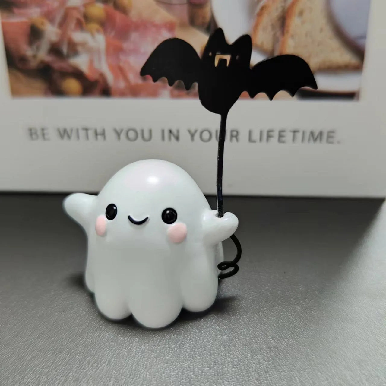 Mini resin statue of a ghost walking a dog and holding a bat, Halloween decoration.