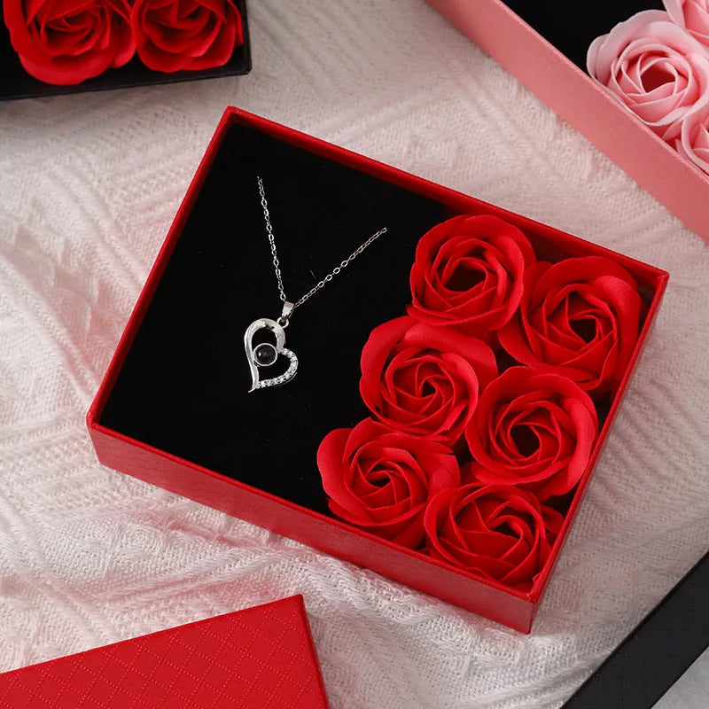 Six red soap flowers arranged in a black gift box with a matching handbag, a Valentine's Day gift set.