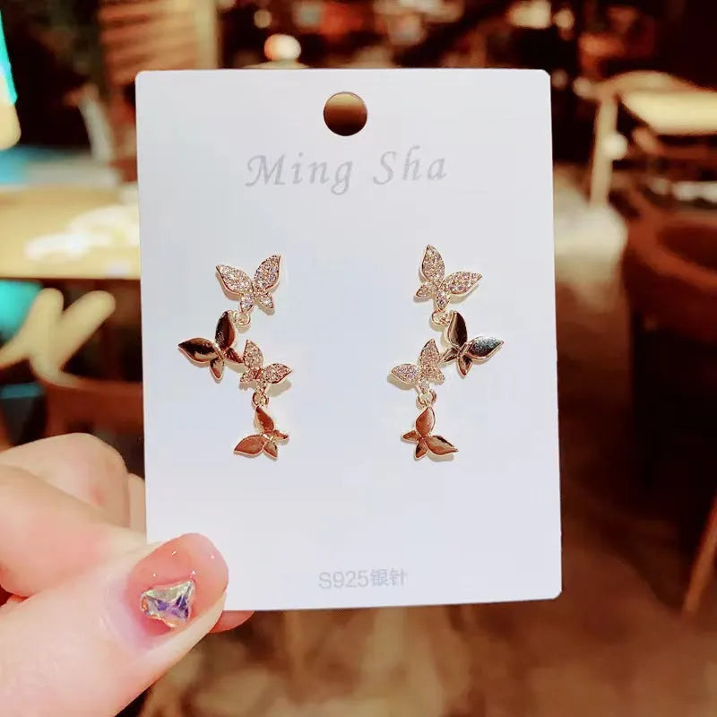 Women's copper earrings with four butterfly designs and gold butterfly-shaped pendant drops