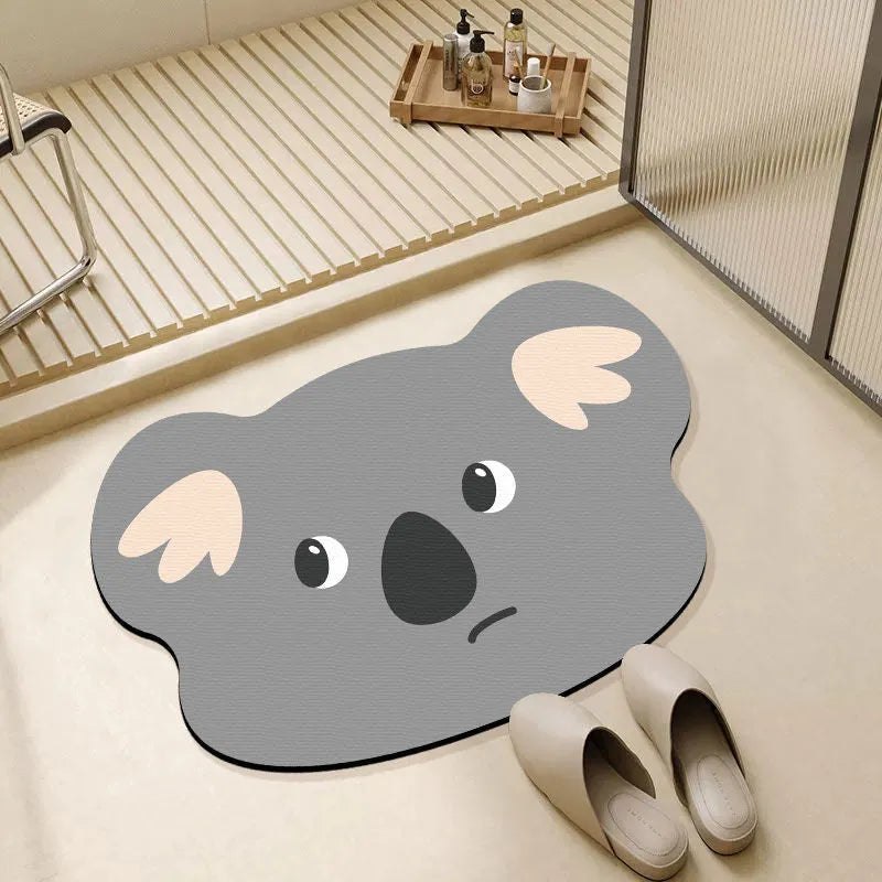 Cartoon animal diatom oil absorbent non-slip bathroom mat in alien shape on a bathroom floor.